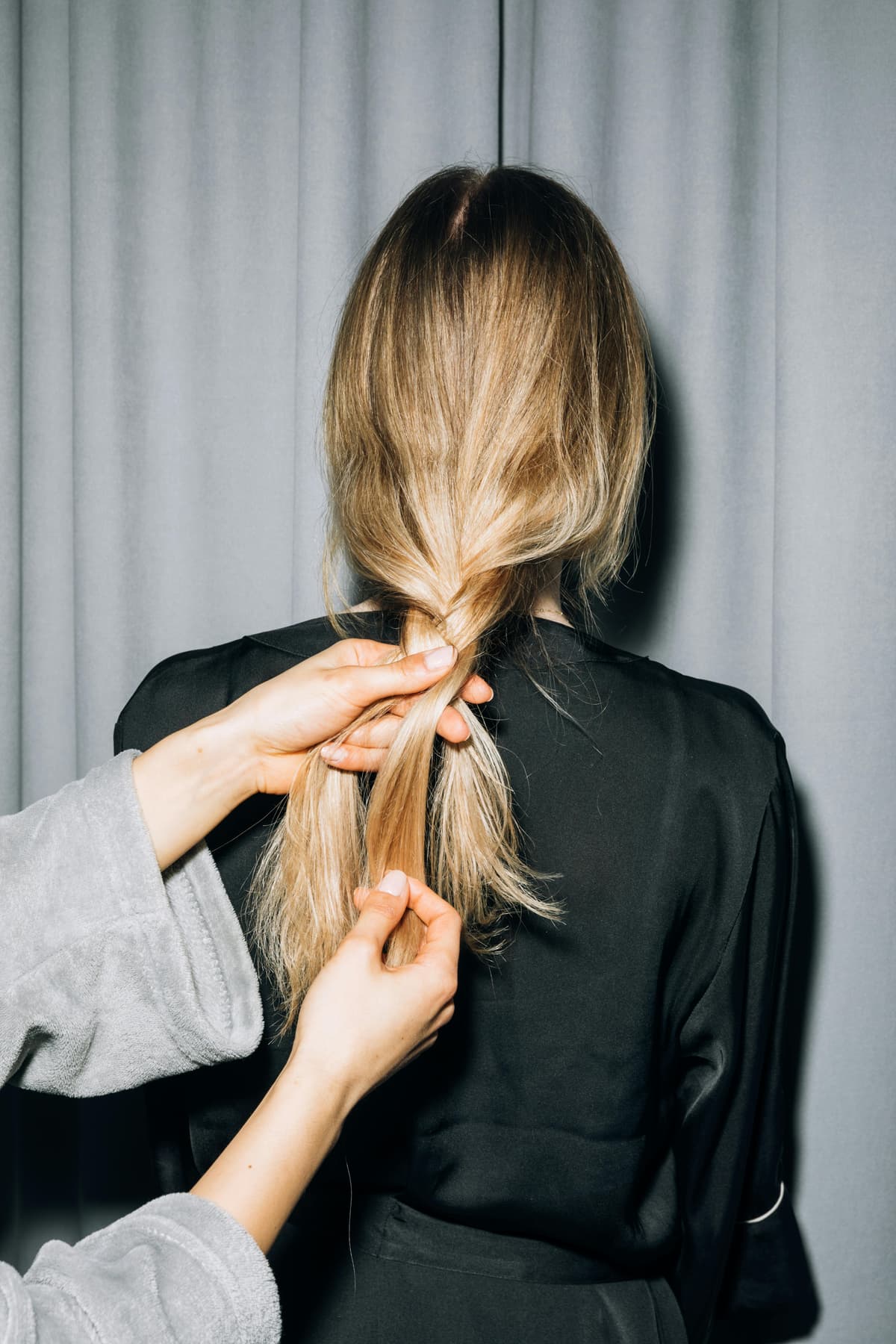 A stylist showing off their work